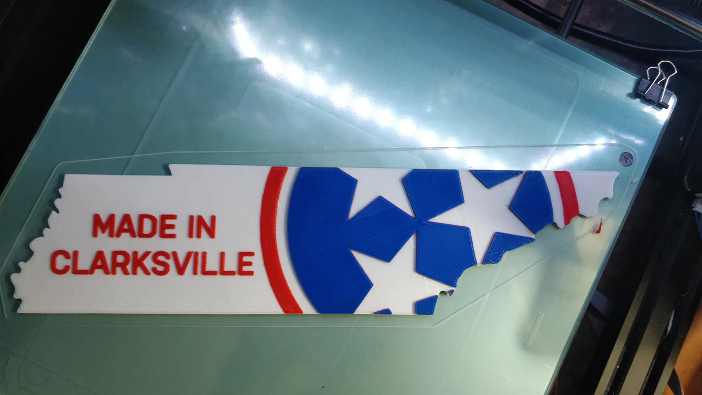 A 3D Printed decoration in the shape of TN